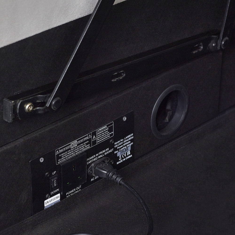 Back of a black electronic device with a power cable plugged in, showing labels and connectors | Light Grey