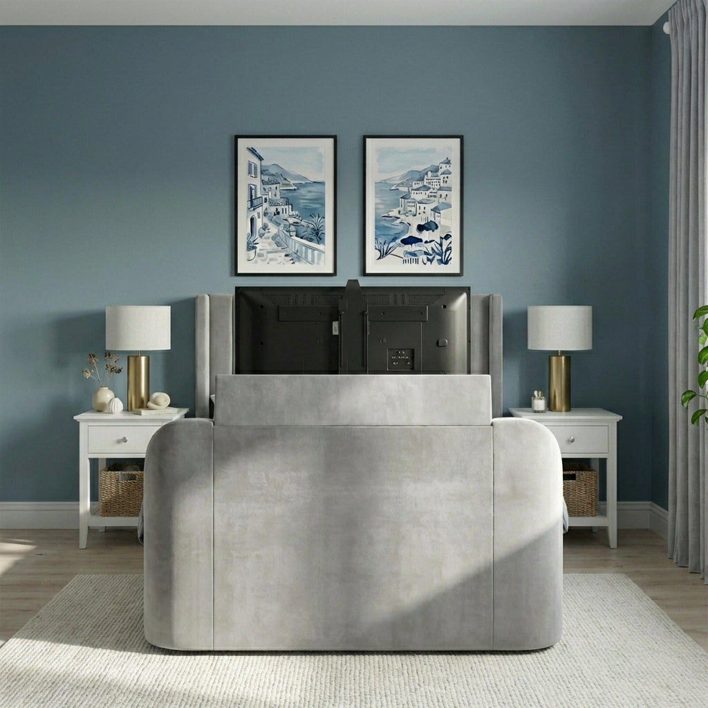 Gray upholstered bed in a room with blue walls, framed artwork, and nightstands | Light Grey
