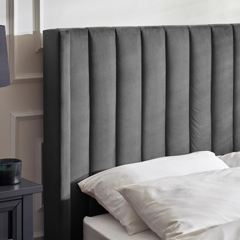 Gray upholstered headboard with white bedding in a bedroom setting | Dark Grey
