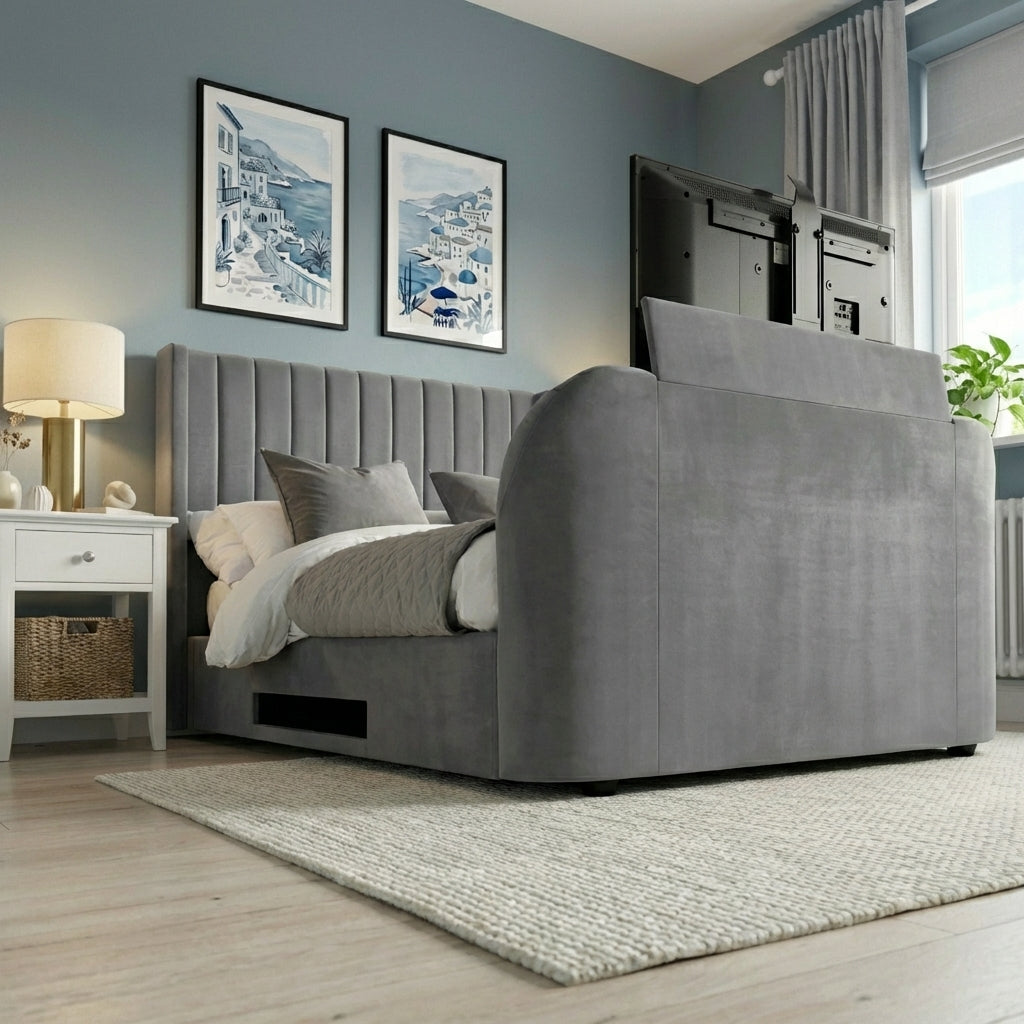 Gray upholstered bed in a room with framed artwork on the wall and a lamp | Dark Grey
