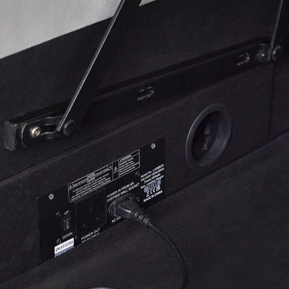 Back of a black electronic device with a power cable plugged in, showing labels and connectors | Light Grey