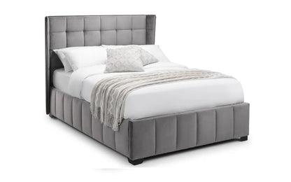 Gray upholstered bed with white bedding on a white background | Grey Velvet