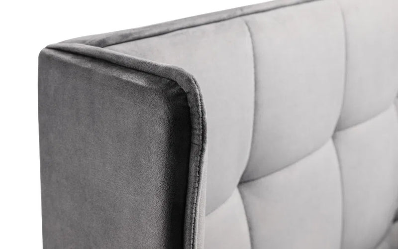 Close-up of a tufted headboard with gray and white quilted design | Grey Velvet