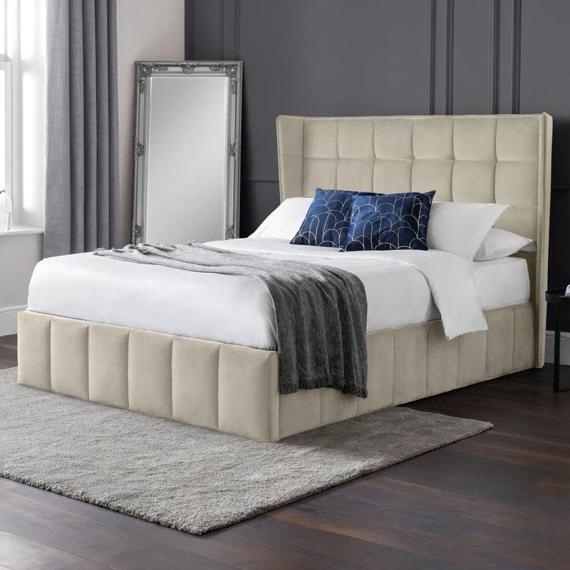 Beige upholstered bed with white bedding and blue pillows in a bedroom setting | Cream Velvet