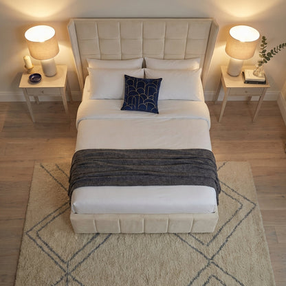 Neatly made bed with decorative pillows in a bedroom setting | Cream Velvet 